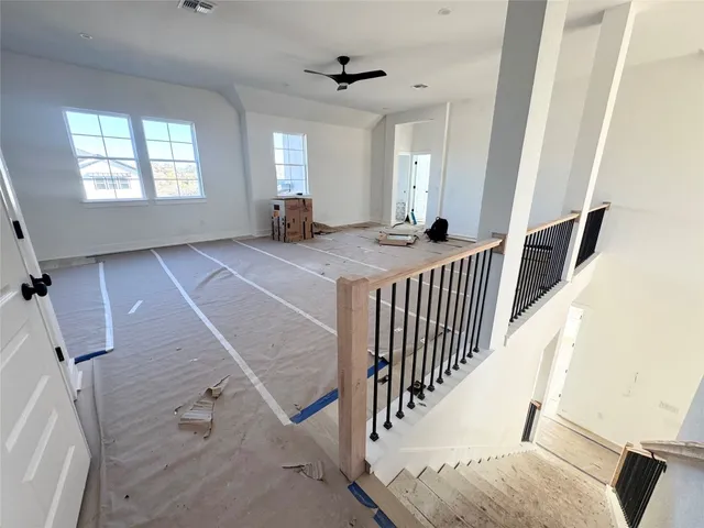 a view of a livingroom with stairs and furniture
