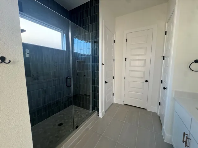 a bathroom with a shower and a sink