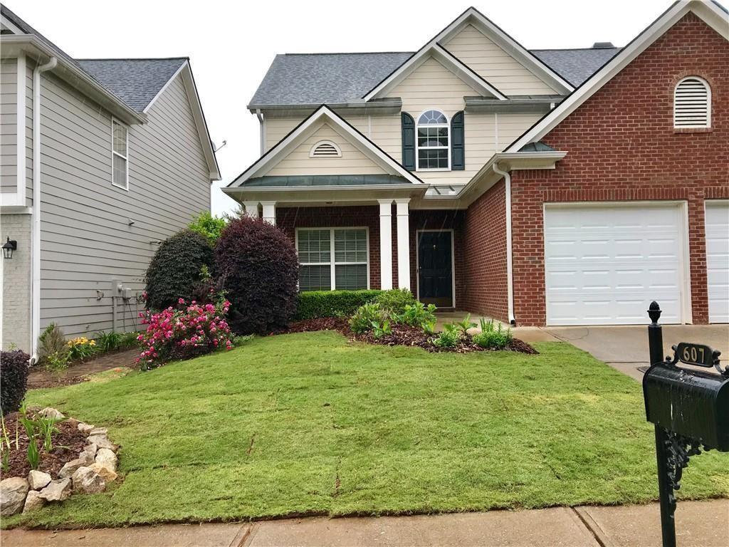 a front view of a house with garden