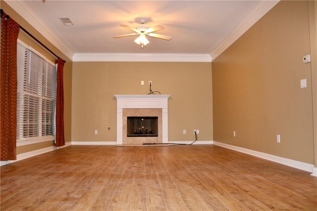 607 Hidden Close Woodstock, GA 30188 - Photo 5 of 11 a view of an empty room with a fireplace and a window