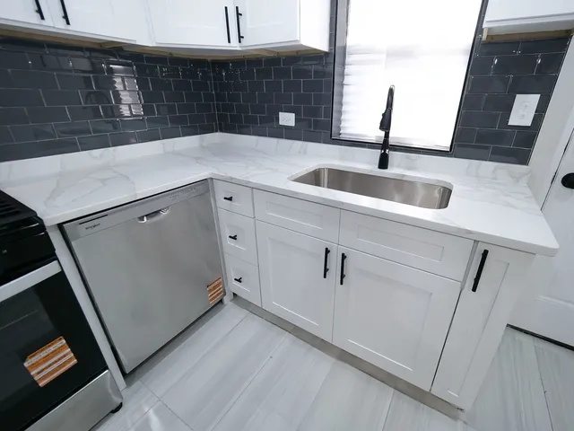 a kitchen with a sink and cabinets