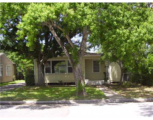 3428 Austin Street Corpus Christi, TX 78411 - Photo 2 of 2 a front view of a house with a garden and trees