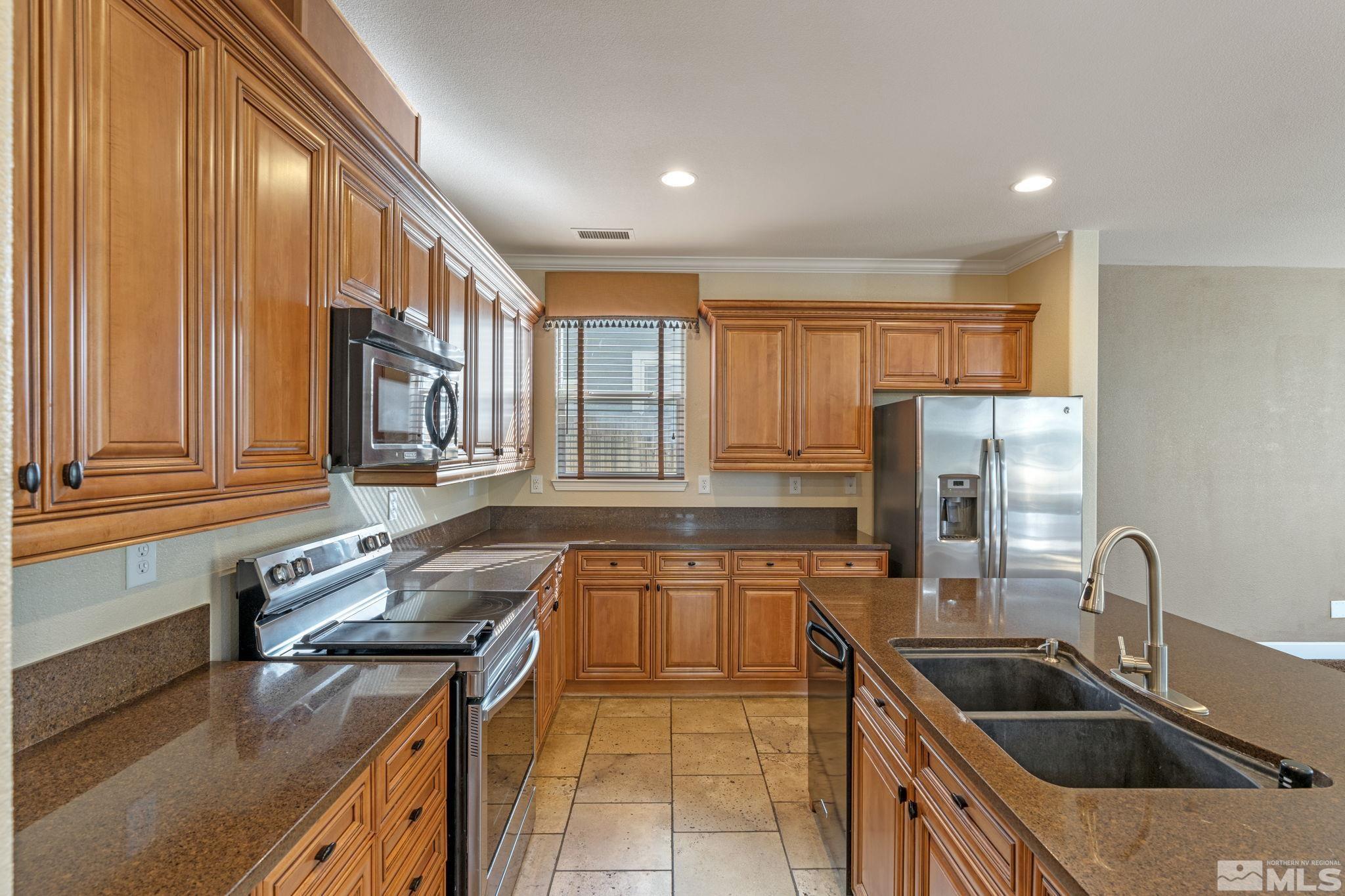 1980 Angel Ridge Drive Reno, NV 89521 - Photo 13 of 39 a kitchen with stainless steel appliances granite countertop a sink and a stove