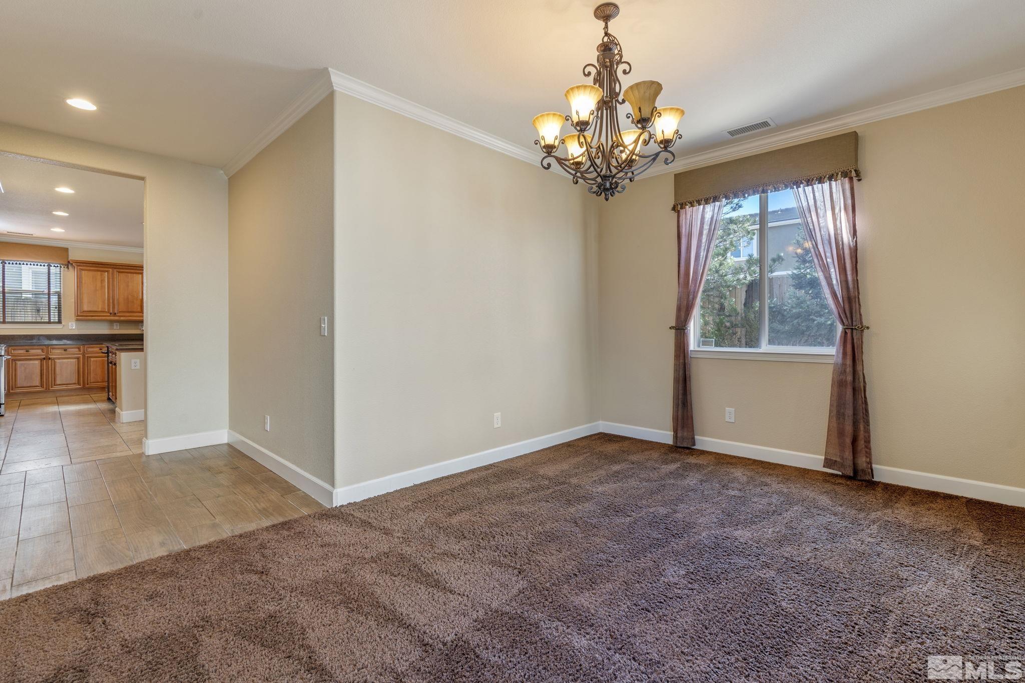 1980 Angel Ridge Drive Reno, NV 89521 - Photo 16 of 39 an empty room with chandelier and windows