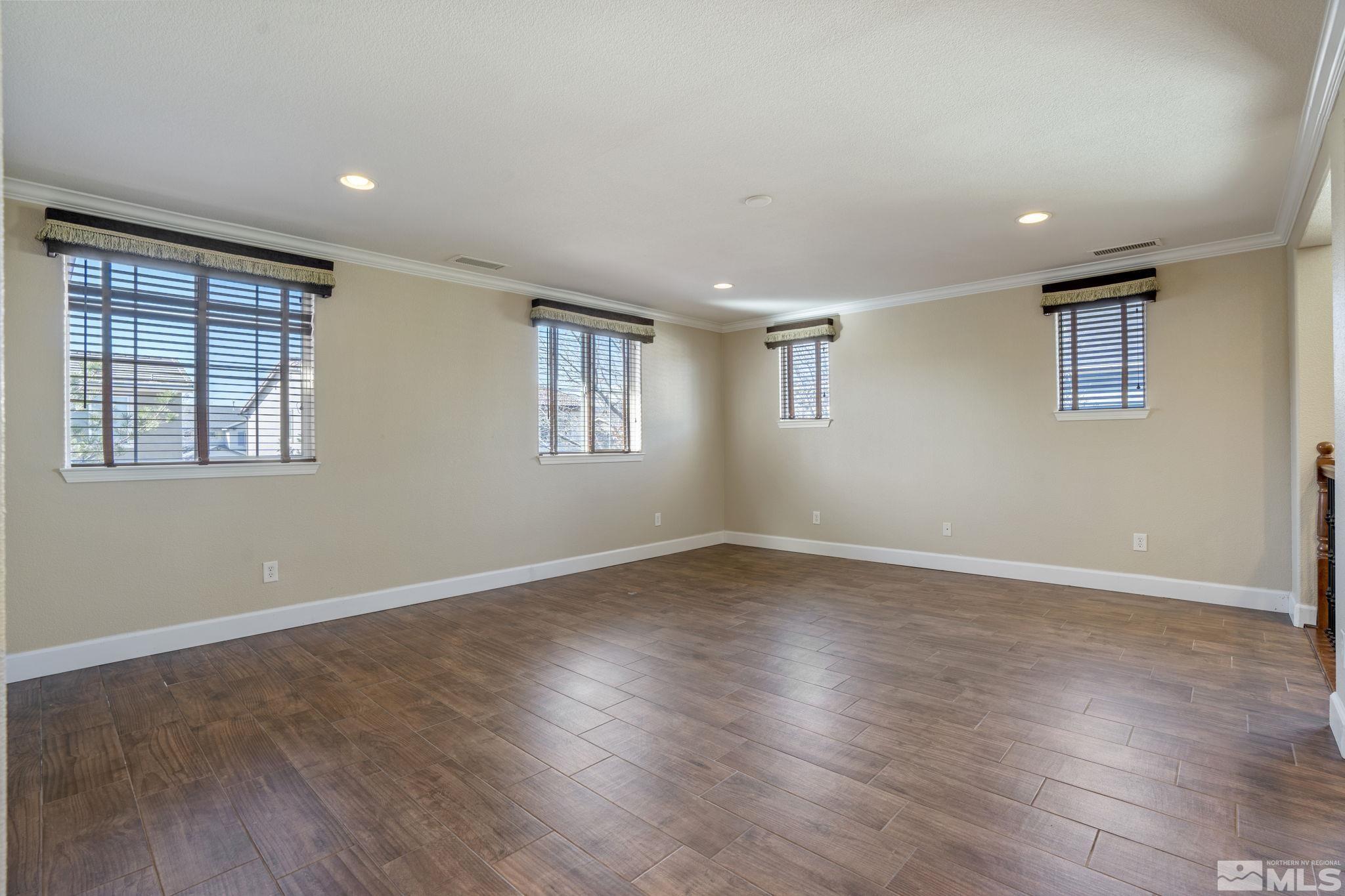 1980 Angel Ridge Drive Reno, NV 89521 - Photo 19 of 39 a view of an empty room with wooden floor and a window