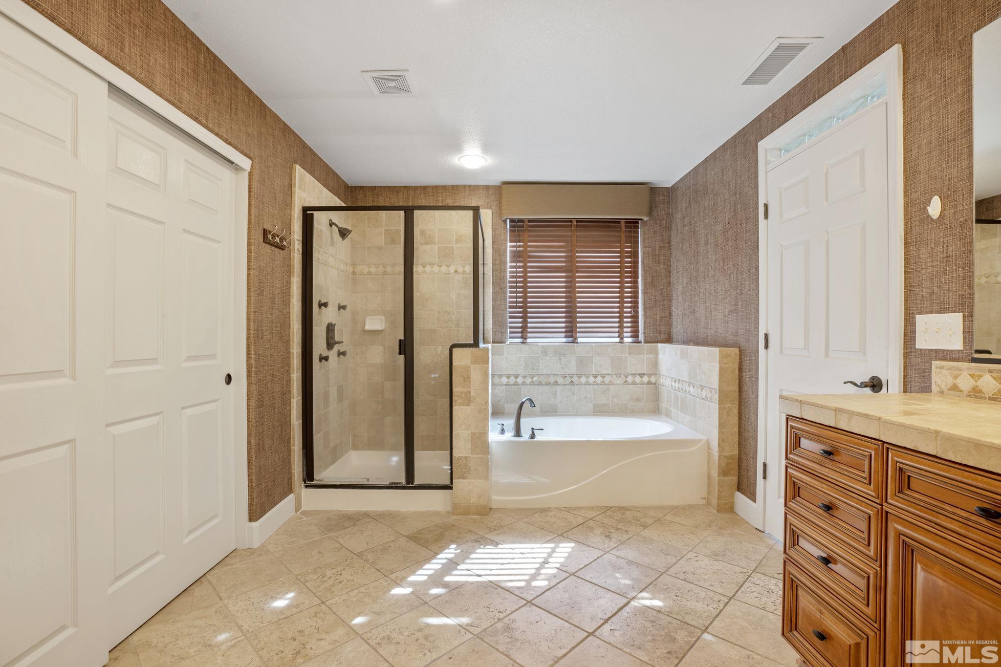 1980 Angel Ridge Drive Reno, NV 89521 - Photo 23 of 39 a bathroom with a bathtub sink and mirror