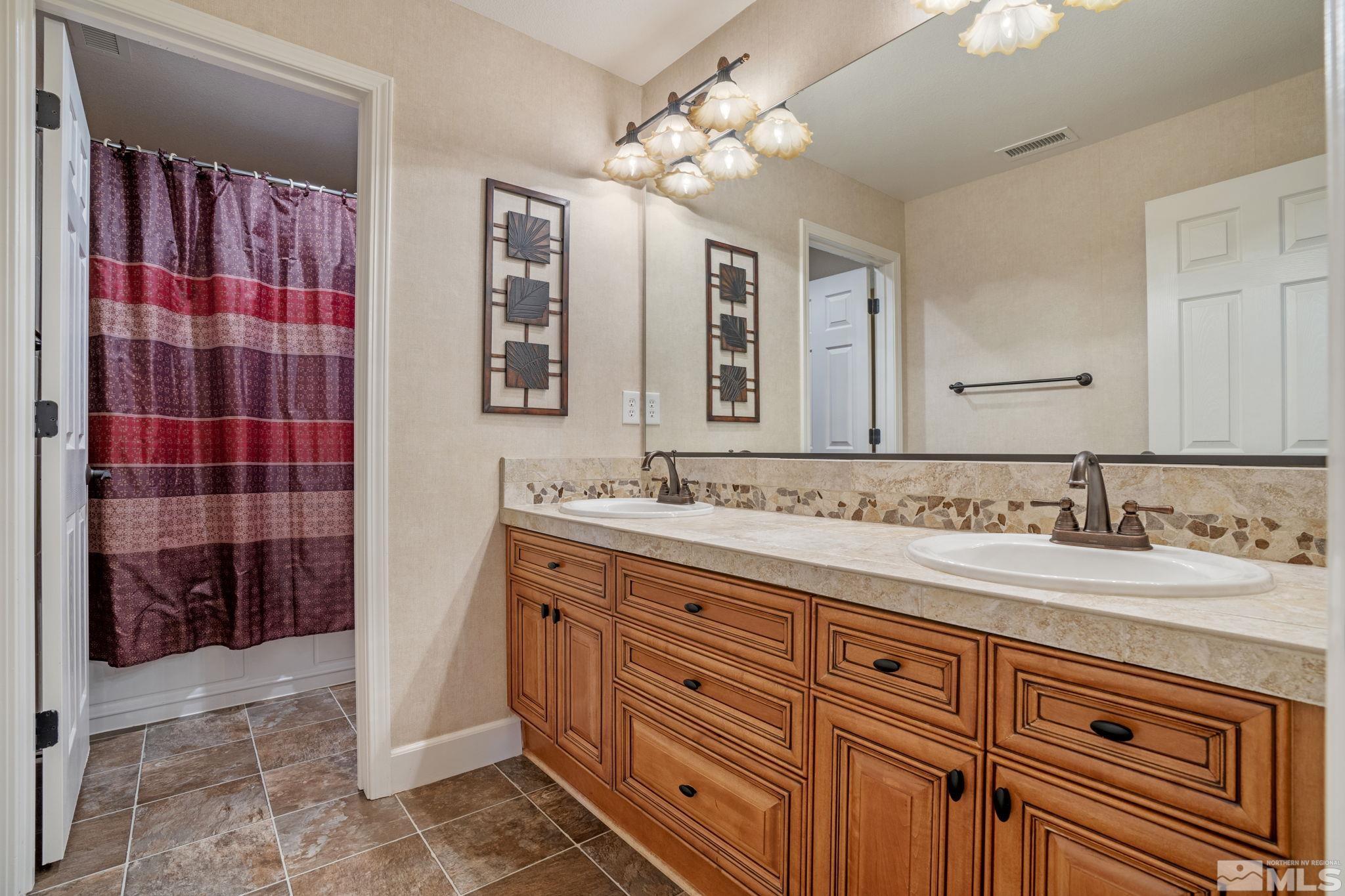 1980 Angel Ridge Drive Reno, NV 89521 - Photo 27 of 39 a bathroom with a double vanity sink mirror and shower