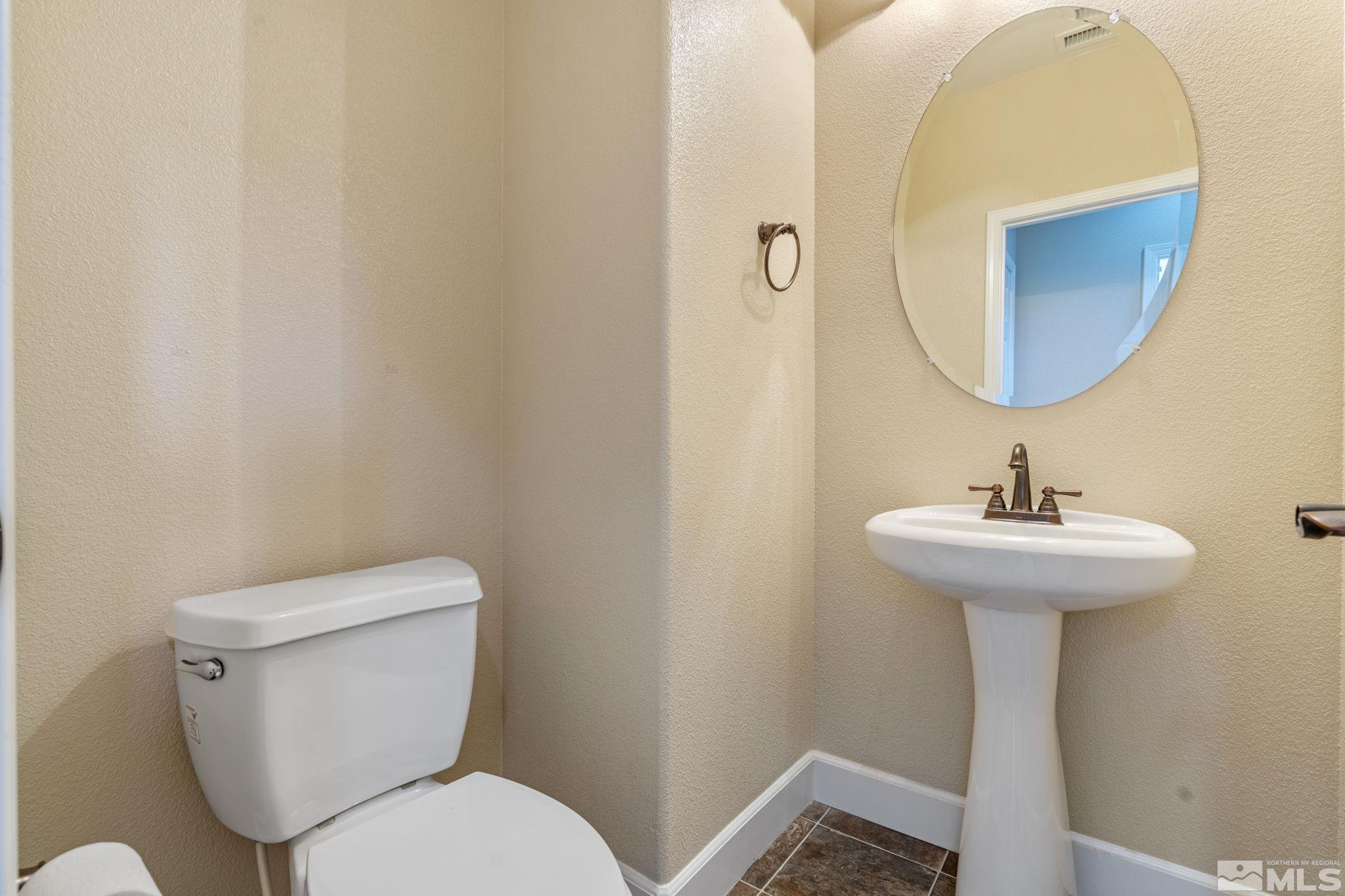 1980 Angel Ridge Drive Reno, NV 89521 - Photo 30 of 39 a bathroom with a toilet sink and mirror