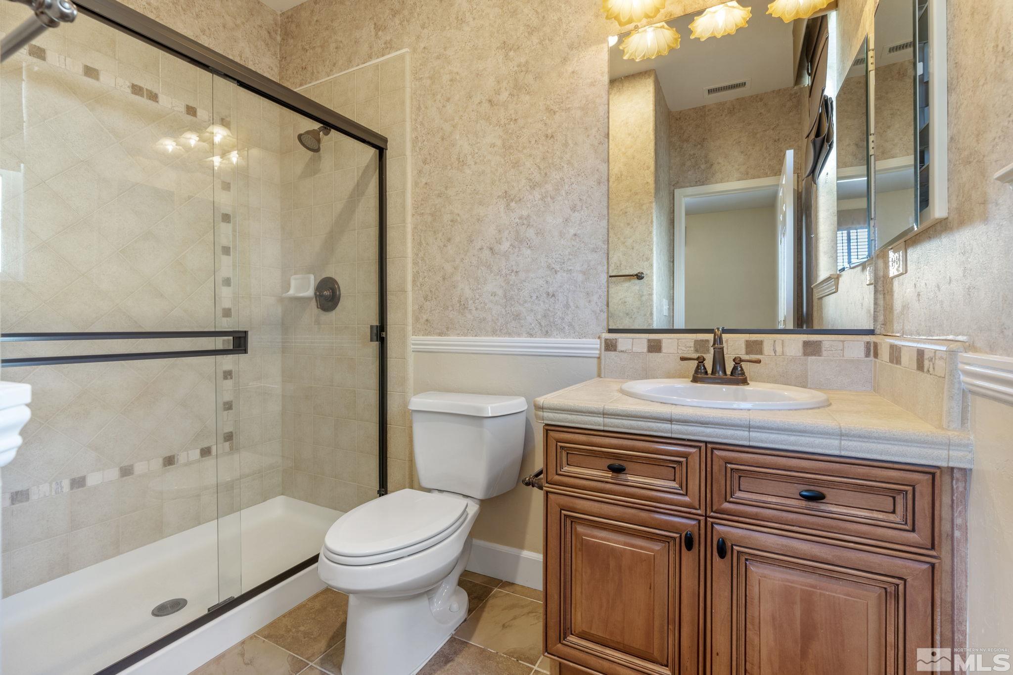 1980 Angel Ridge Drive Reno, NV 89521 - Photo 35 of 39 a bathroom with a sink a toilet and shower