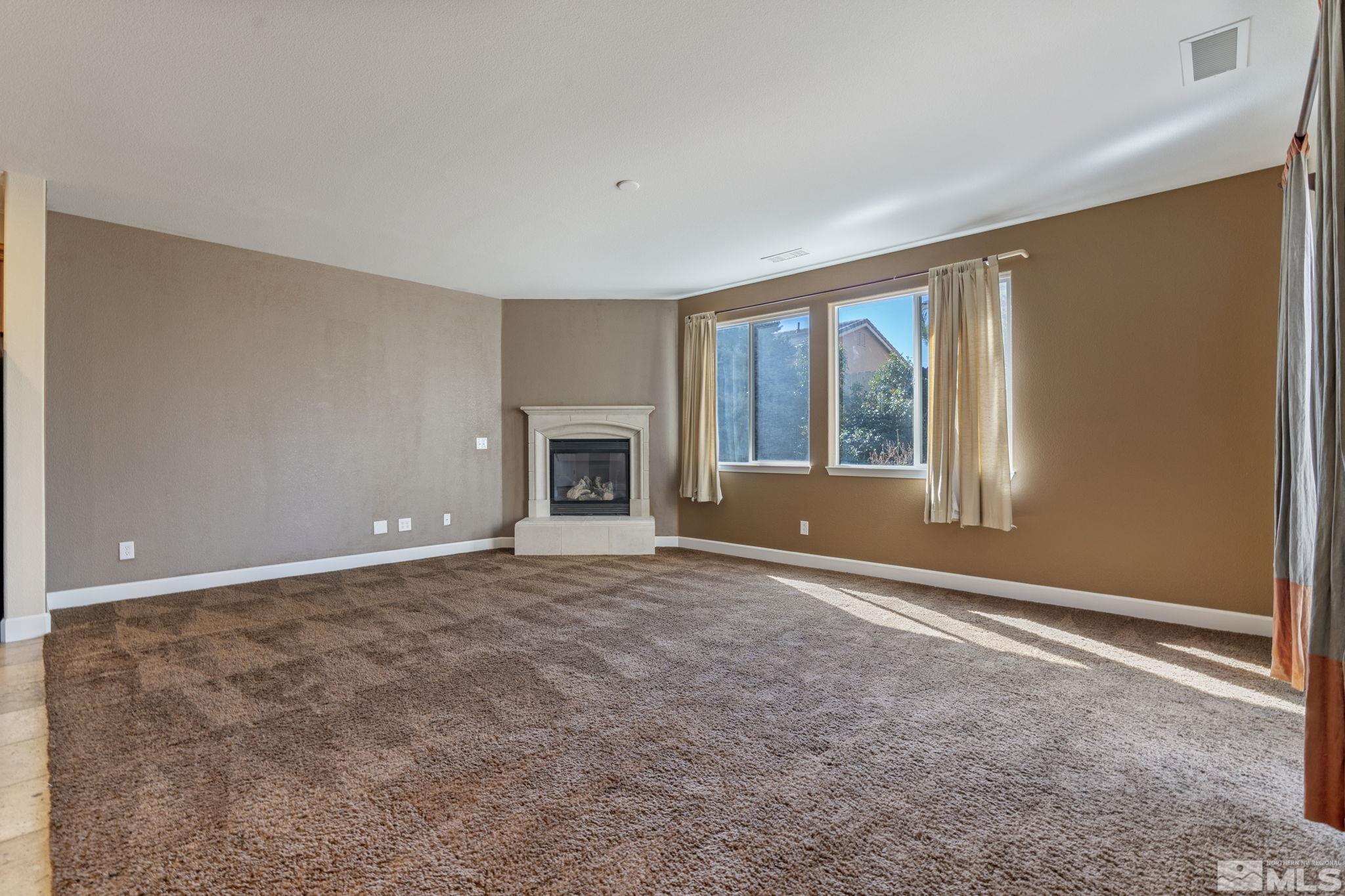 1980 Angel Ridge Drive Reno, NV 89521 - Photo 10 of 39 a view of an empty room with window and fire place