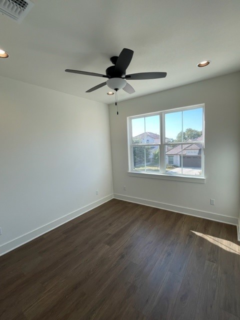 137 Limestone Drive Georgetown, TX 78628 - Photo 14 of 18 a view of an empty room with wooden floor and a window