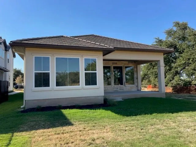 a view of a house with yard and a garden