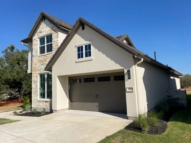 a front view of a house with garage