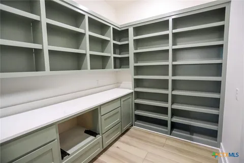 a view of storage and utility room with empty racks