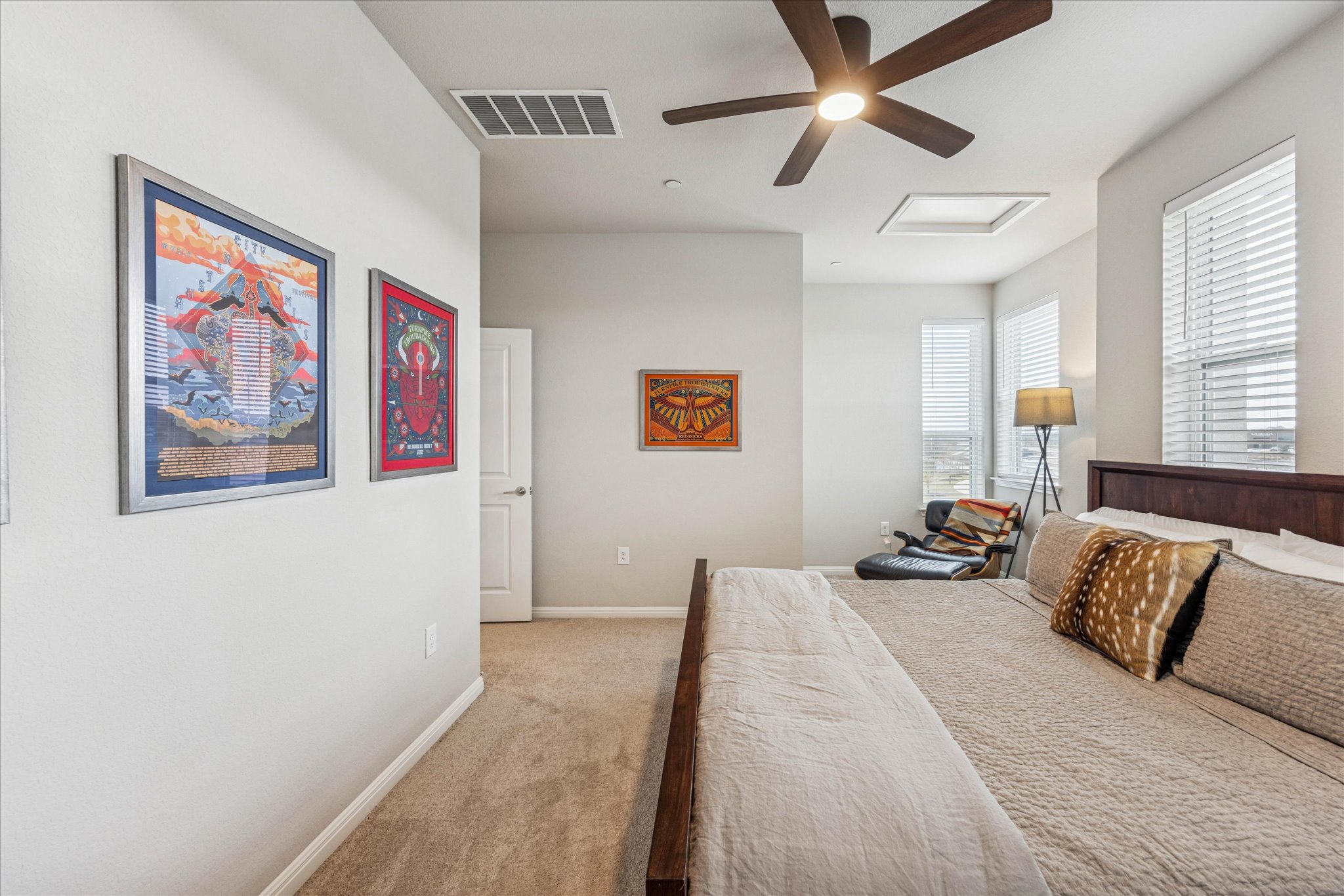 9015 Cattle Baron Path, Unit 1002 Austin, TX 78747 - Photo 16 of 20 a spacious bedroom with a bed and a painting on the wall