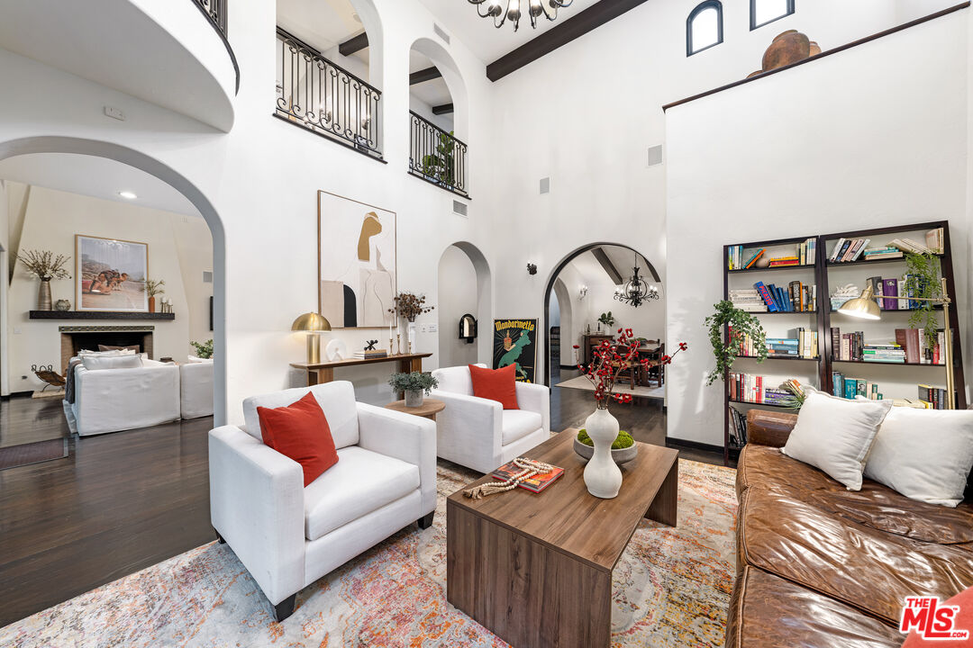 3606 Mandeville Canyon Road Los Angeles, CA 90049 - Photo 12 of 32 a living room with furniture a rug and white walls