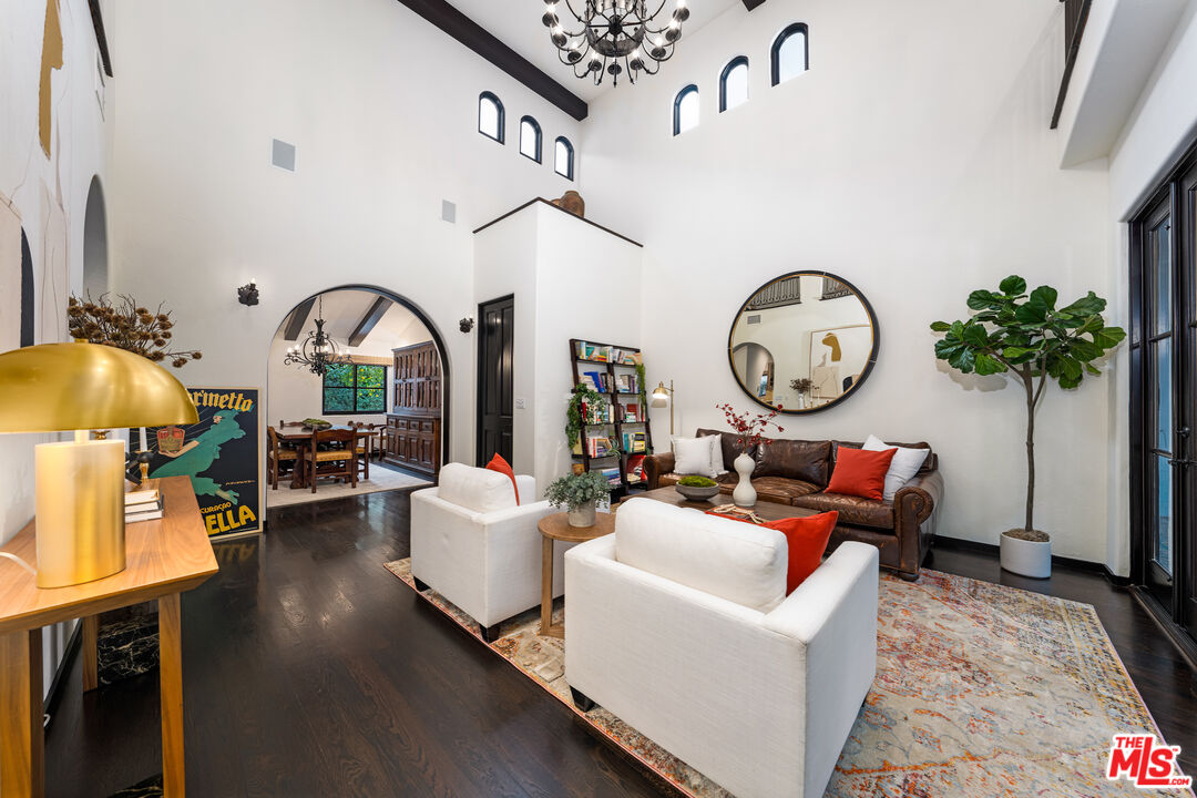 3606 Mandeville Canyon Road Los Angeles, CA 90049 - Photo 13 of 32 a living room with furniture a clock and a window