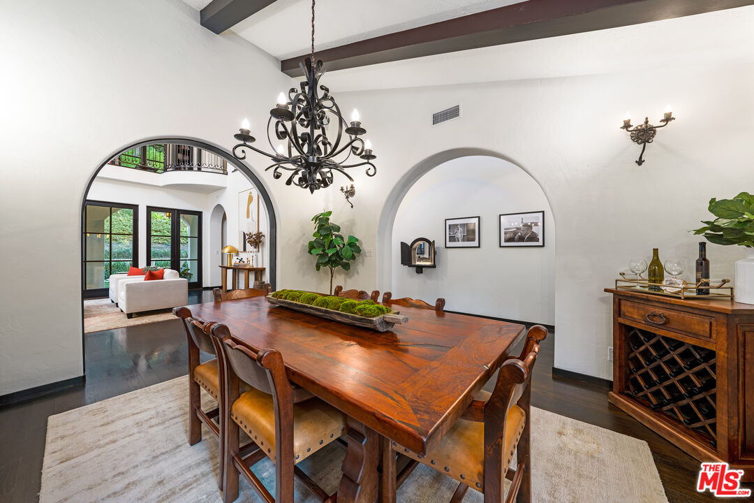 3606 Mandeville Canyon Road Los Angeles, CA 90049 - Photo 15 of 32 a view of a dining room with furniture window and wooden floor