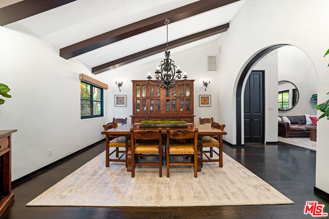 3606 Mandeville Canyon Road Los Angeles, CA 90049 - Photo 16 of 32 a living room with furniture and a chandelier