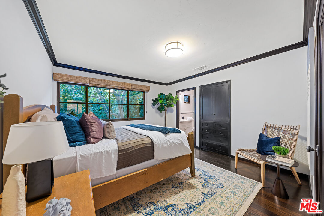 3606 Mandeville Canyon Road Los Angeles, CA 90049 - Photo 20 of 32 a bedroom with a large bed and a window