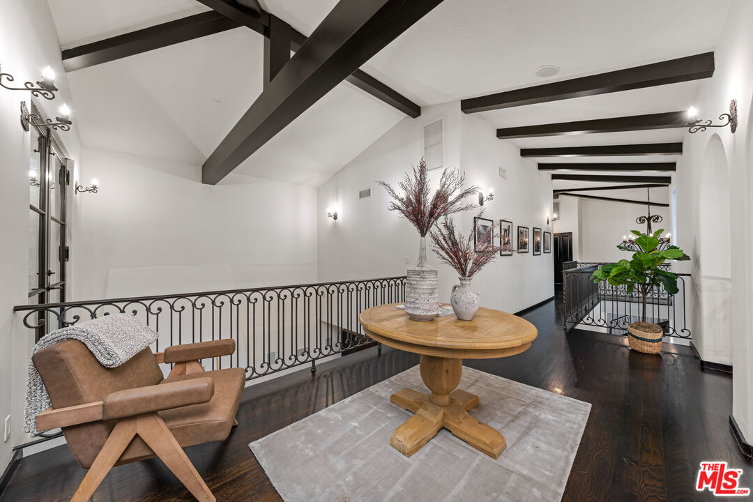 3606 Mandeville Canyon Road Los Angeles, CA 90049 - Photo 24 of 32 a living room with couches a table and a potted plant