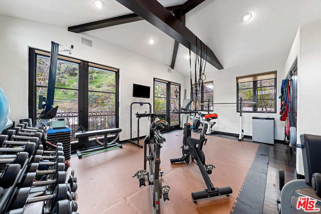 3606 Mandeville Canyon Road Los Angeles, CA 90049 - Photo 27 of 32 a view of a room with gym equipment