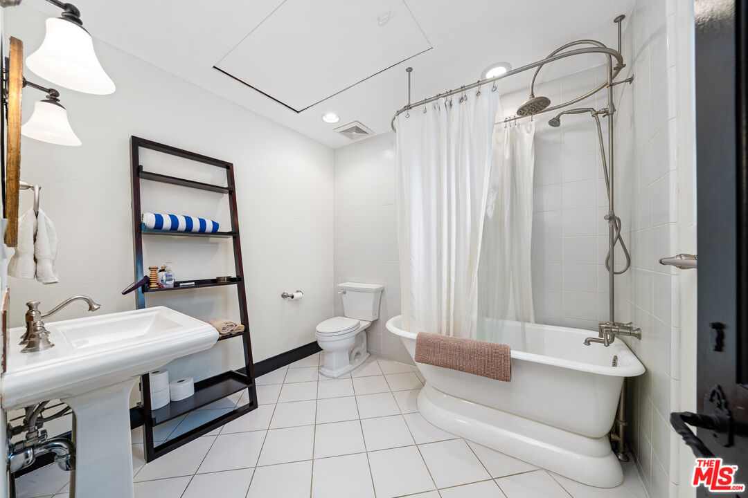3606 Mandeville Canyon Road Los Angeles, CA 90049 - Photo 29 of 32 a bathroom with a sink and mirror