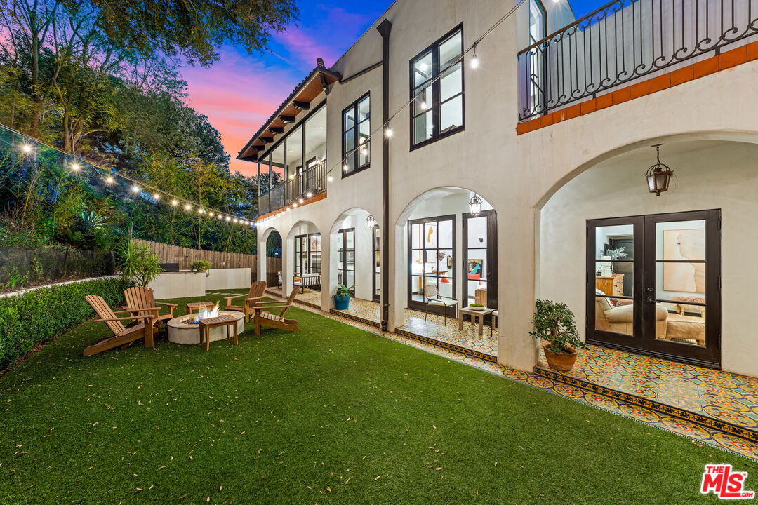3606 Mandeville Canyon Road Los Angeles, CA 90049 - Photo 30 of 32 a view of a house with backyard porch and sitting area