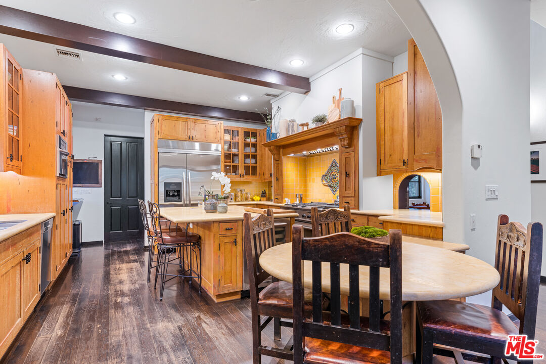3606 Mandeville Canyon Road Los Angeles, CA 90049 - Photo 10 of 32 a view of a dining room with furniture window and wooden floor