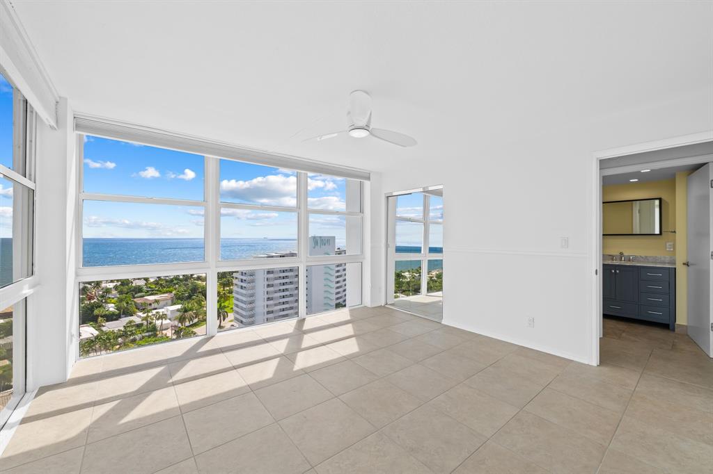 2841 North Ocean Boulevard, Unit 1710 Fort Lauderdale, FL 33308 - Photo 12 of 34 a view of an empty room with wooden floor and a window