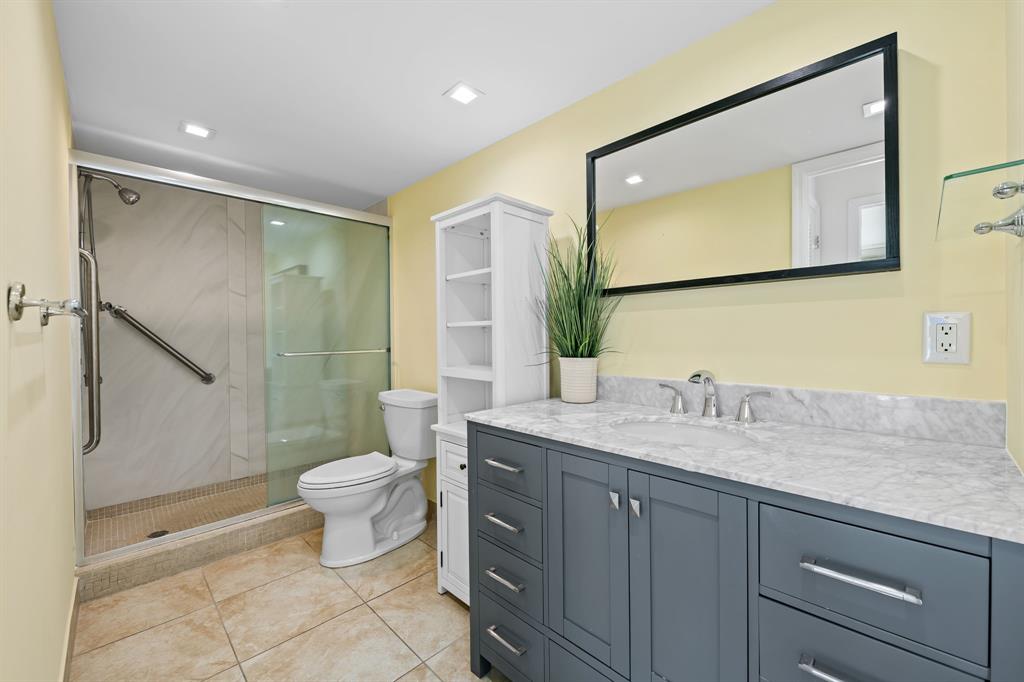 2841 North Ocean Boulevard, Unit 1710 Fort Lauderdale, FL 33308 - Photo 13 of 34 a bathroom with a granite countertop sink toilet and shower