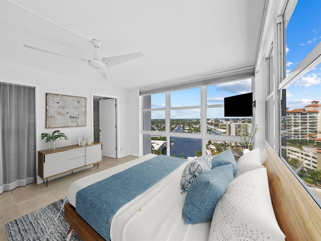 2841 North Ocean Boulevard, Unit 1710 Fort Lauderdale, FL 33308 - Photo 2 of 34 a living room with furniture and a flat screen tv