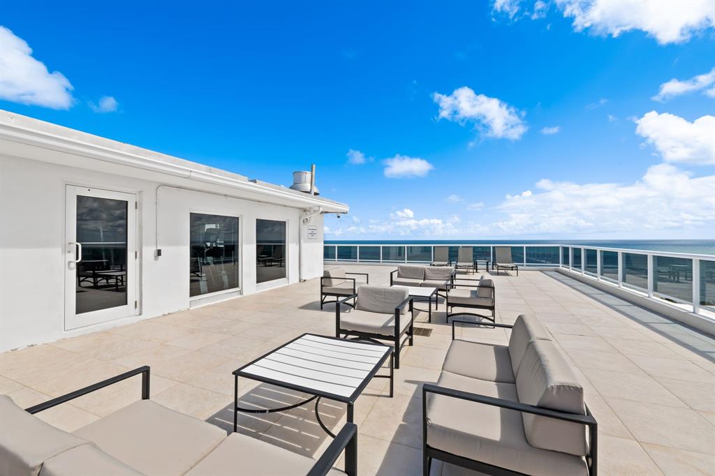 2841 North Ocean Boulevard, Unit 1710 Fort Lauderdale, FL 33308 - Photo 25 of 34 a view of a patio with table and chairs and potted plants