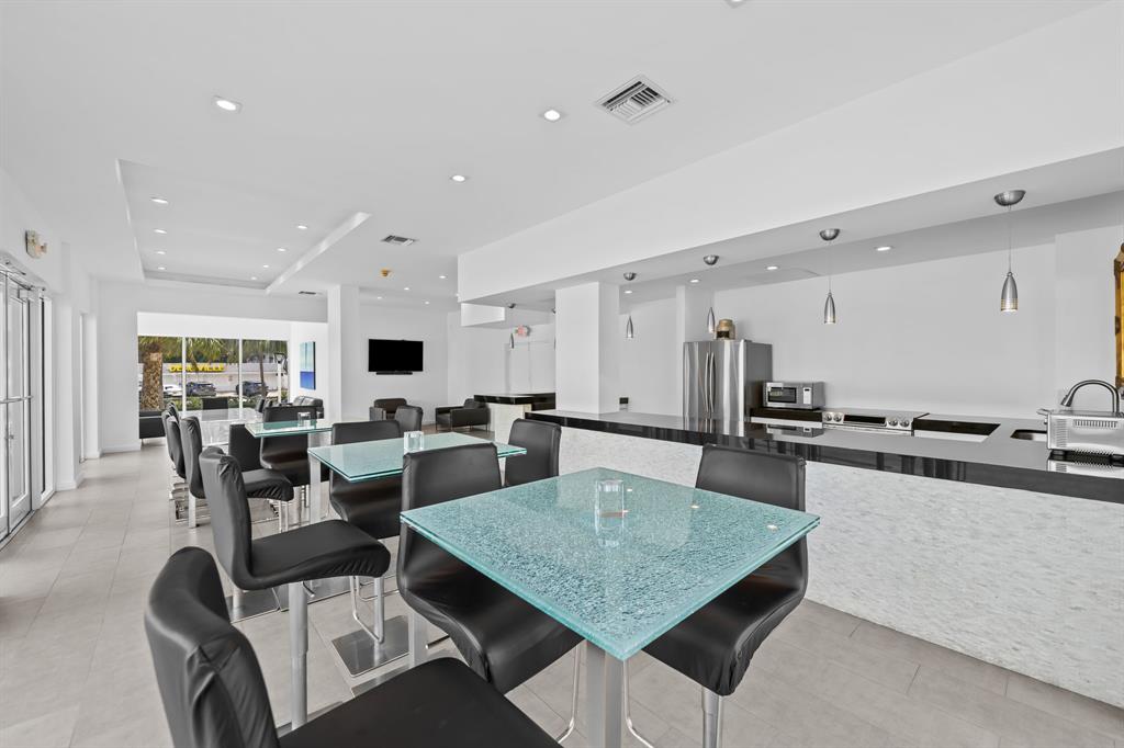 2841 North Ocean Boulevard, Unit 1710 Fort Lauderdale, FL 33308 - Photo 29 of 34 a large kitchen with a table and chairs