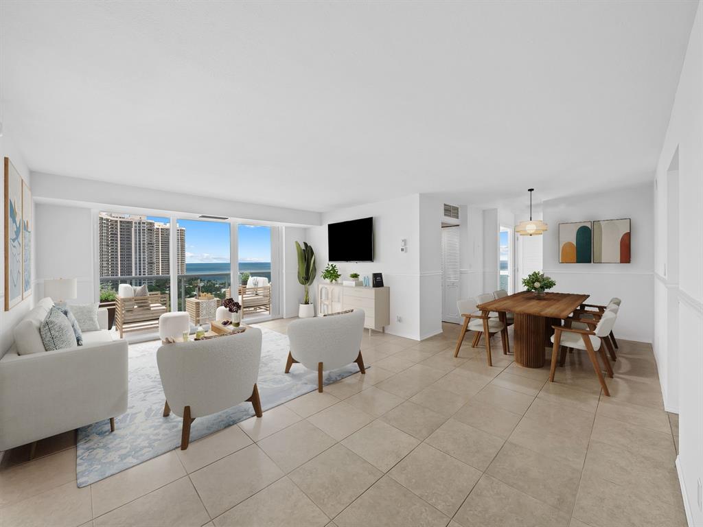 2841 North Ocean Boulevard, Unit 1710 Fort Lauderdale, FL 33308 - Photo 3 of 34 a living room with furniture and a flat screen tv