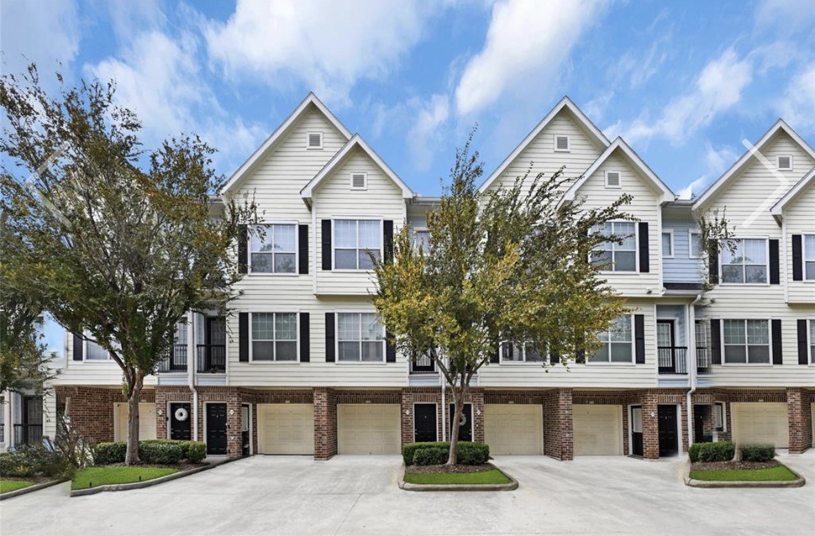 a view of multiple houses with a street