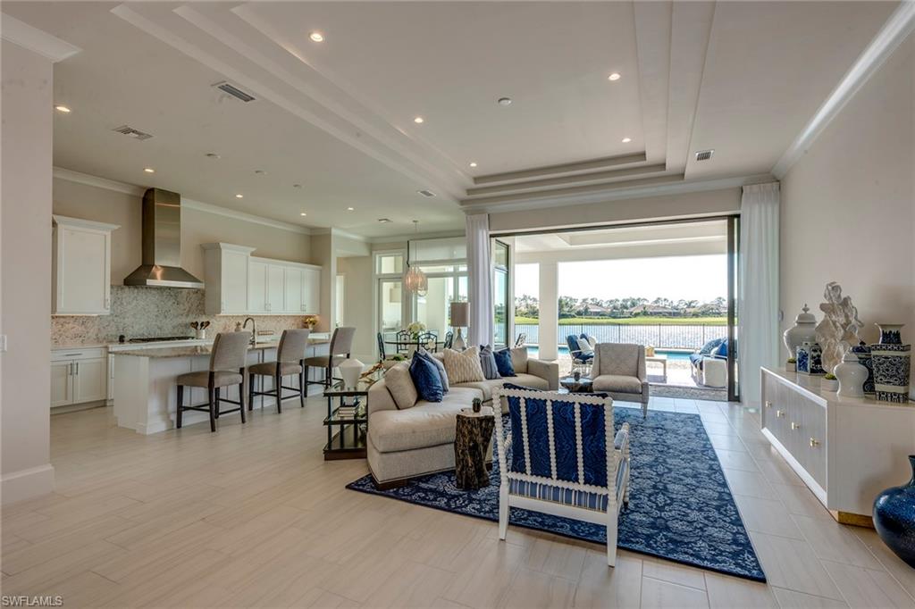 9828 Montiano Place Naples, FL 34113 - Photo 11 of 30 a living room with lots of furniture and a large window