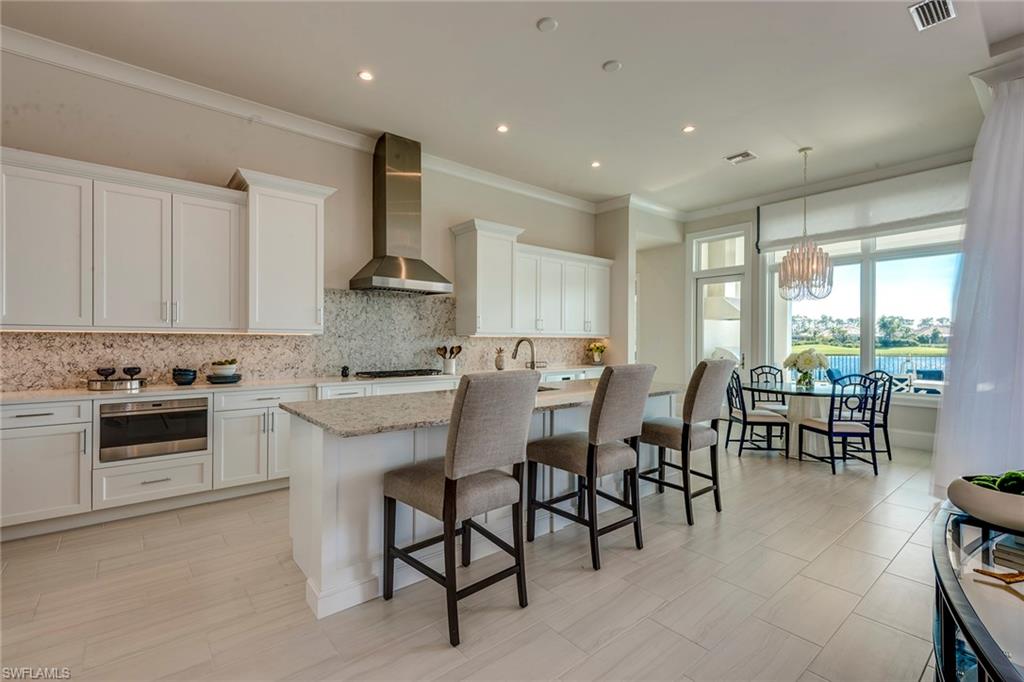 9828 Montiano Place Naples, FL 34113 - Photo 15 of 30 a kitchen with appliances a sink and cabinets