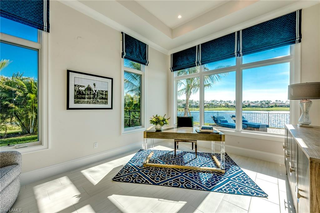 9828 Montiano Place Naples, FL 34113 - Photo 21 of 30 a living room with a rug floor and a table
