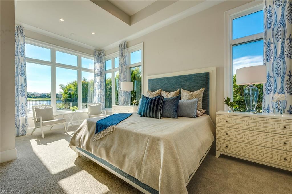9828 Montiano Place Naples, FL 34113 - Photo 23 of 30 a bedroom with a bed and large window