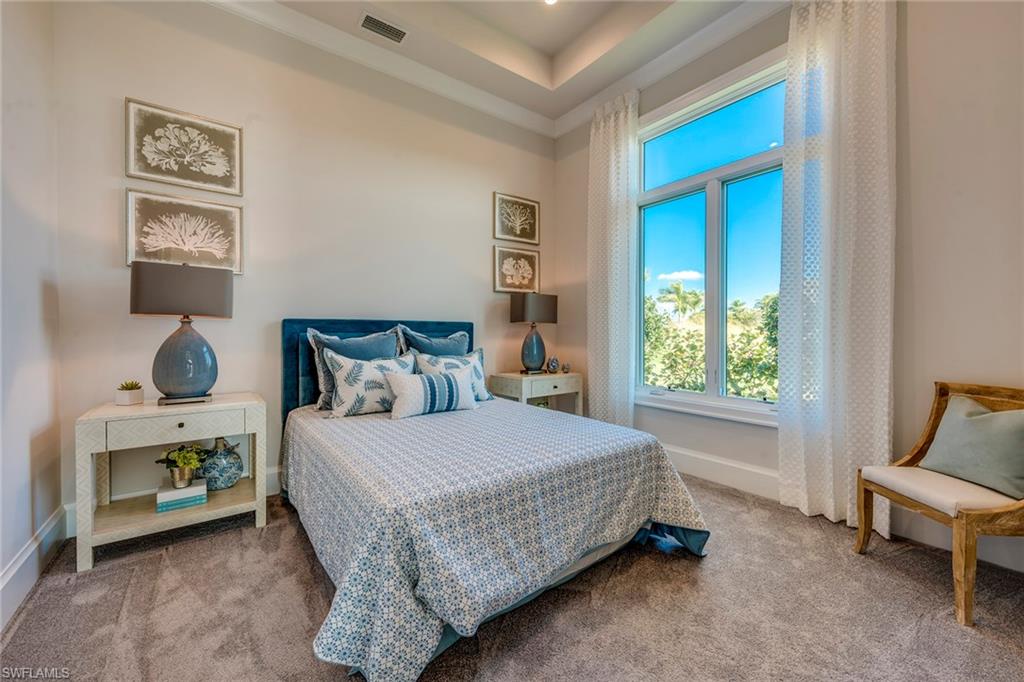 9828 Montiano Place Naples, FL 34113 - Photo 27 of 30 a bedroom with a bed and a window