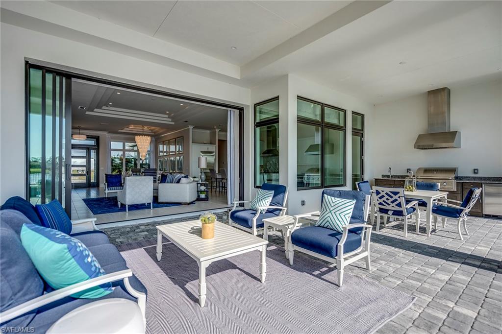 9828 Montiano Place Naples, FL 34113 - Photo 5 of 30 a living room with furniture and a large window