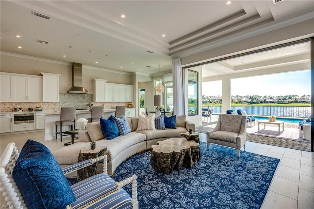9828 Montiano Place Naples, FL 34113 - Photo 8 of 30 a living room with furniture wooden floor and a large window