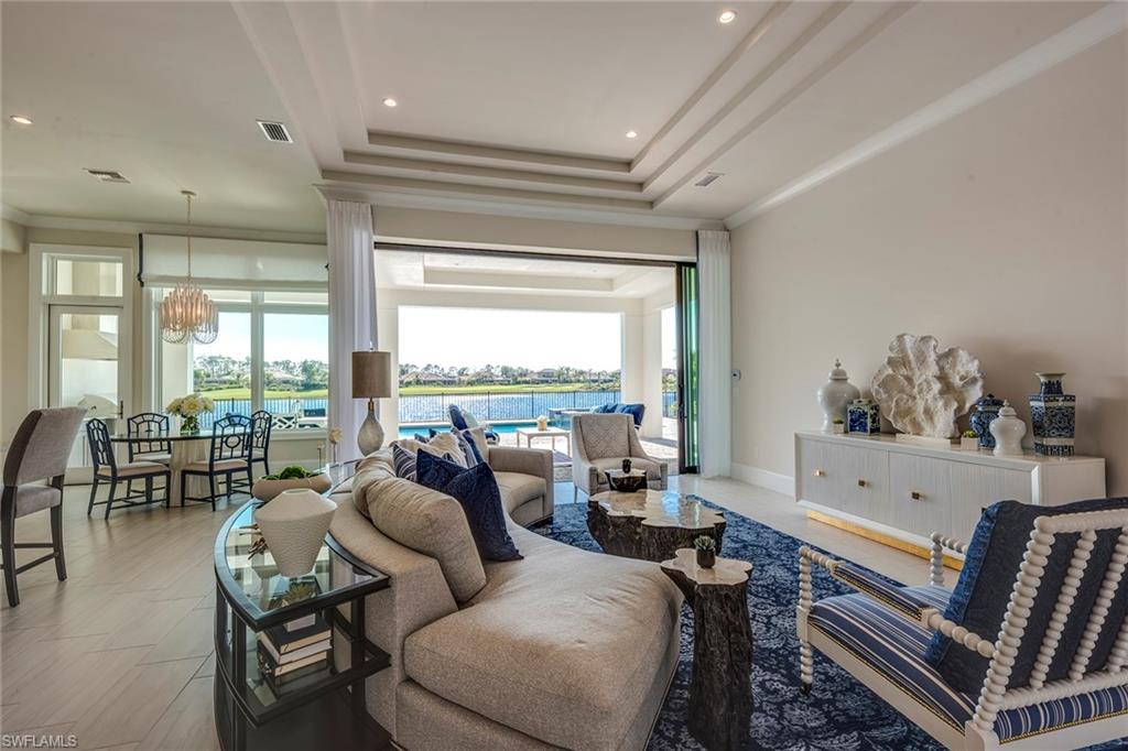 9828 Montiano Place Naples, FL 34113 - Photo 9 of 30 a living room with furniture and a large window