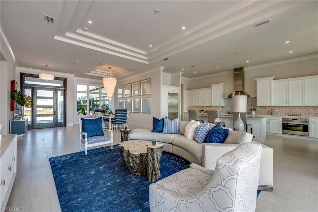 9828 Montiano Place Naples, FL 34113 - Photo 10 of 30 a living room with furniture wooden floor and a large window