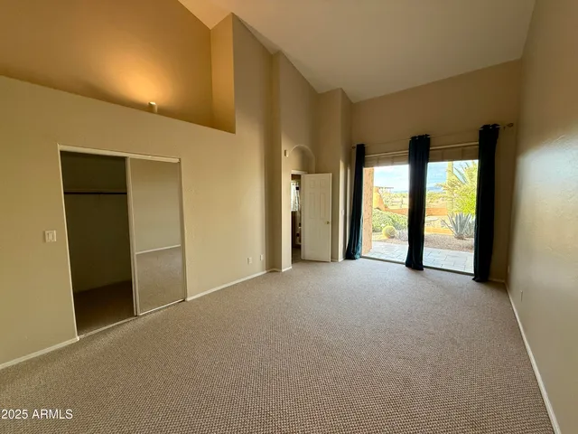 a view of an empty room with large windows