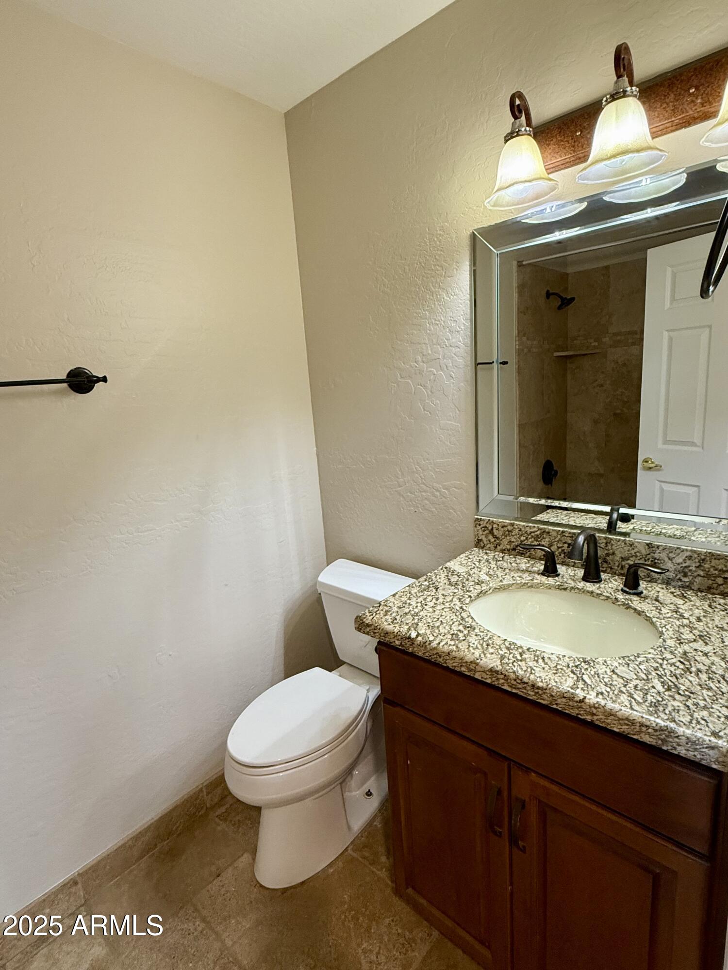 26646 North 148th Street Scottsdale, AZ 85262 - Photo 19 of 37 a bathroom with a granite countertop toilet a mirror and a sink
