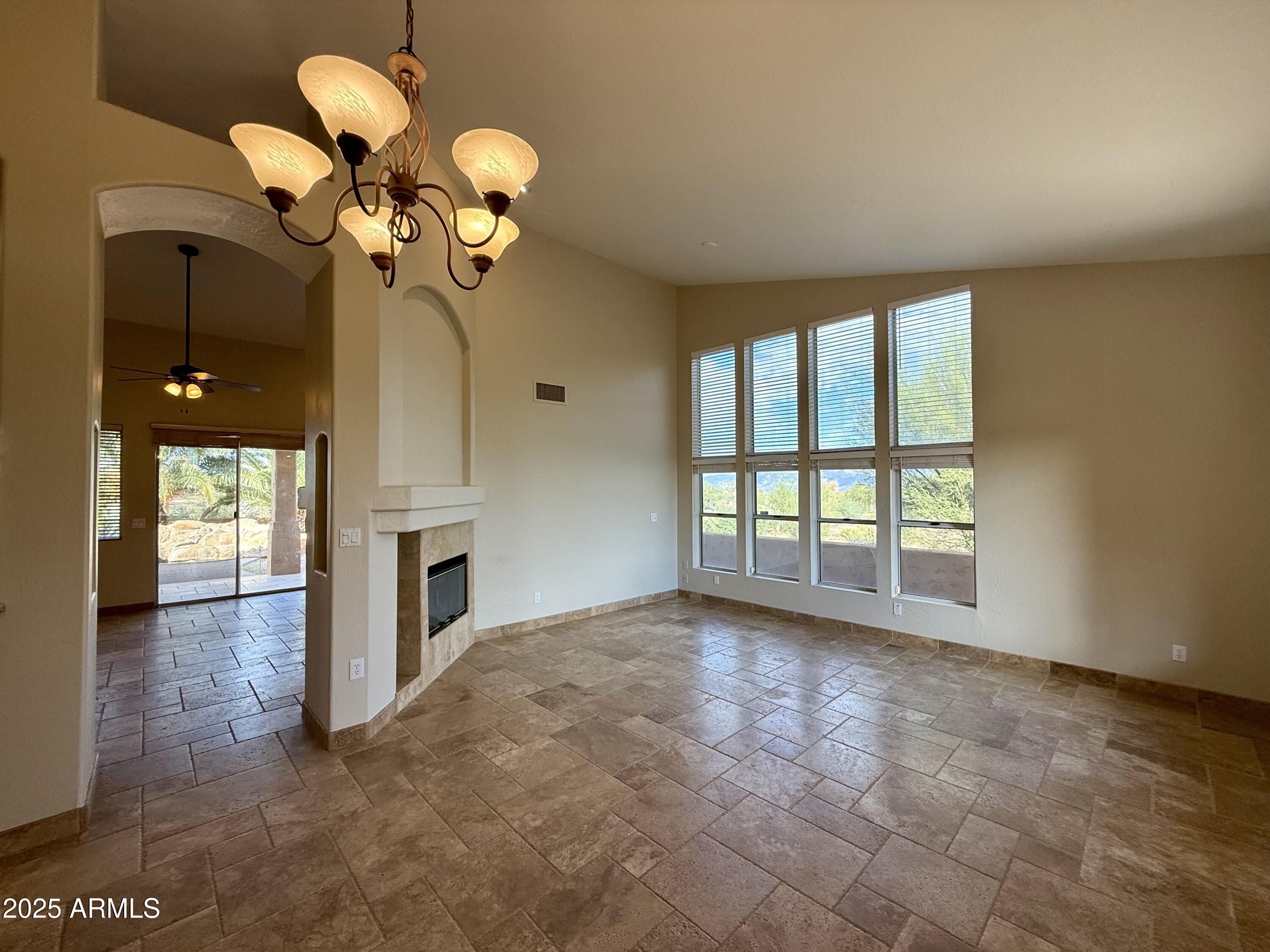 26646 North 148th Street Scottsdale, AZ 85262 - Photo 8 of 37 a view of a livingroom with a chandelier fan and a fireplace