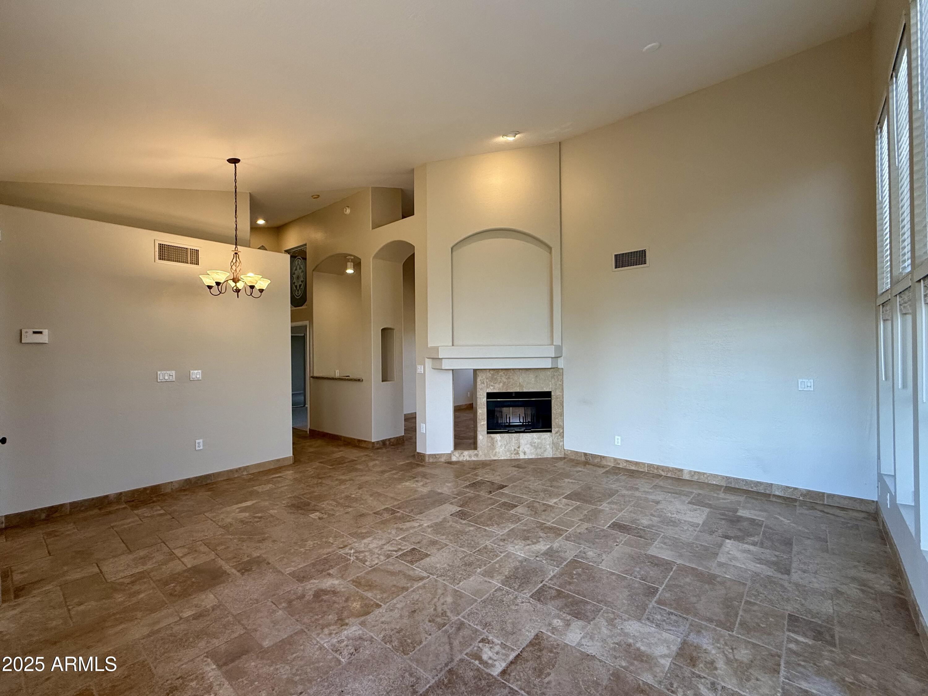 26646 North 148th Street Scottsdale, AZ 85262 - Photo 9 of 37 a view of empty room with fireplace and windows