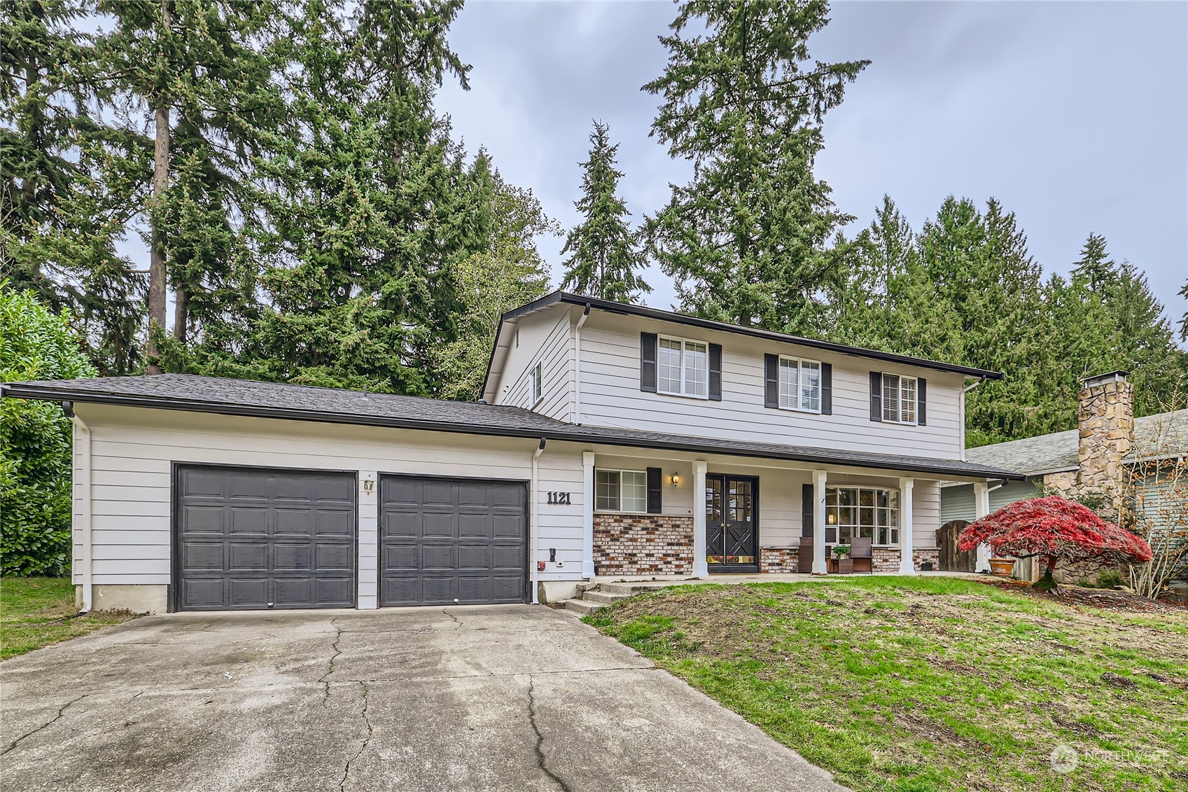 1121 204th Place Southeast Bothell, WA 98012 - Photo 1 of 28 a front view of a house with garden and porch